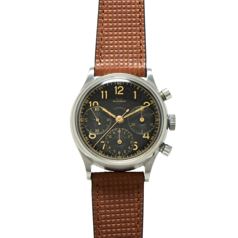 Stainless steel chronograph watch with black dial, gold numerals, three subdials, and brown quilted leather strap.