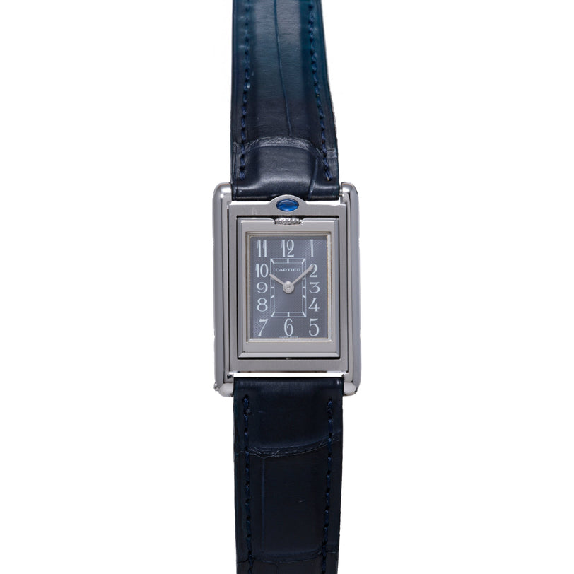 Cartier Tank Basculante watch with rectangular stainless steel case, dark dial, and navy blue leather strap.