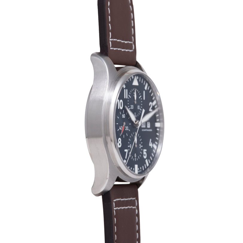 Stainless steel chronograph watch with black dial, multiple subdials, and brown leather strap with contrasting stitching.
