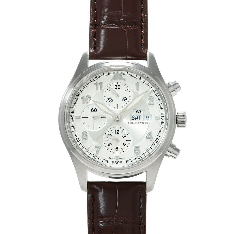 Silver chronograph watch with white dial, three subdials, date window, and dark brown crocodile leather strap.