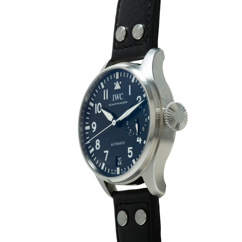 IWC Big Pilot watch with stainless steel case, dark blue dial, Arabic numerals, and black leather strap with metal studs.