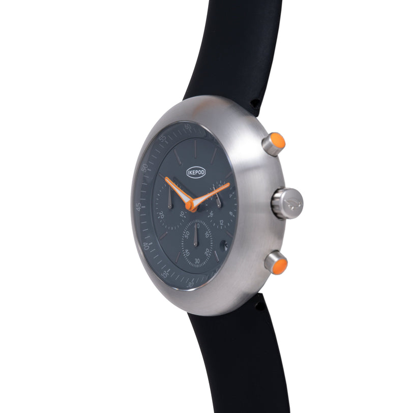 Ikepod Chronopod watch with brushed silver case, black dial, orange hands and pushers, black rubber strap.