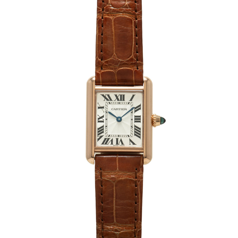 Gold-tone rectangular watch with white dial, Roman numerals, and brown crocodile leather strap.