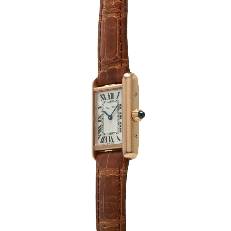 Gold-tone rectangular watch with cream dial, Roman numerals, and brown crocodile leather strap.