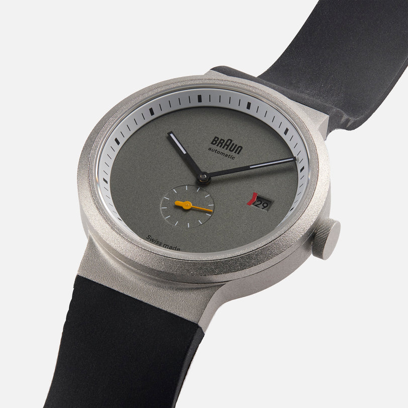 The Braun BN0279 Sub-Seconds Limited Edition for Hodinkee is a modern wristwatch featuring a gray face, date window, small seconds dial, and a black strap.