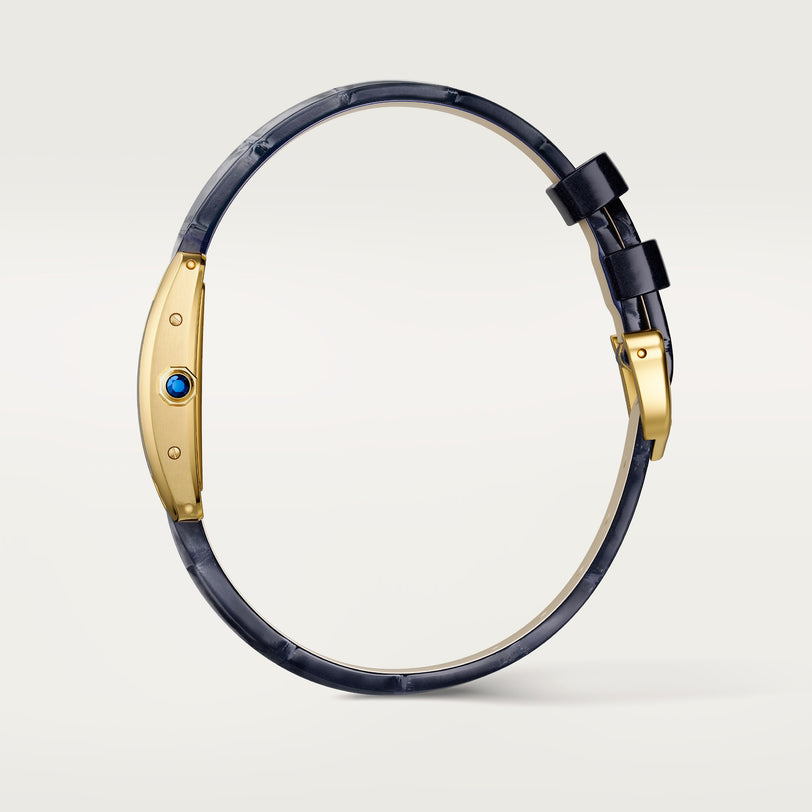 The Cartier Tank Américaine features a luxurious gold rectangular case, white dial with black Roman numerals, blue hands, and a dark blue leather strap—a true timeless classic.