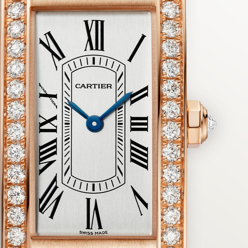 Rose gold rectangular watch with white dial, black Roman numerals, blue hands, diamond-set bezel, and leather strap.