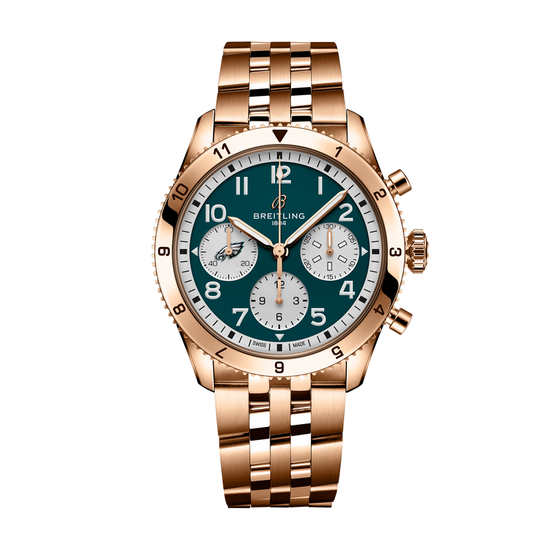 Breitling Classic Avi Chronograph 42 NFL Philadelphia Eagles Edition with a green dial, three subdials, and a metal link bracelet, shown on a black background.