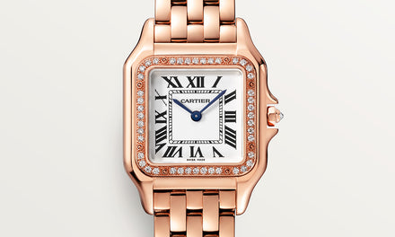 A close up view of a jeweled Cartier watch with a rose gold bracelet