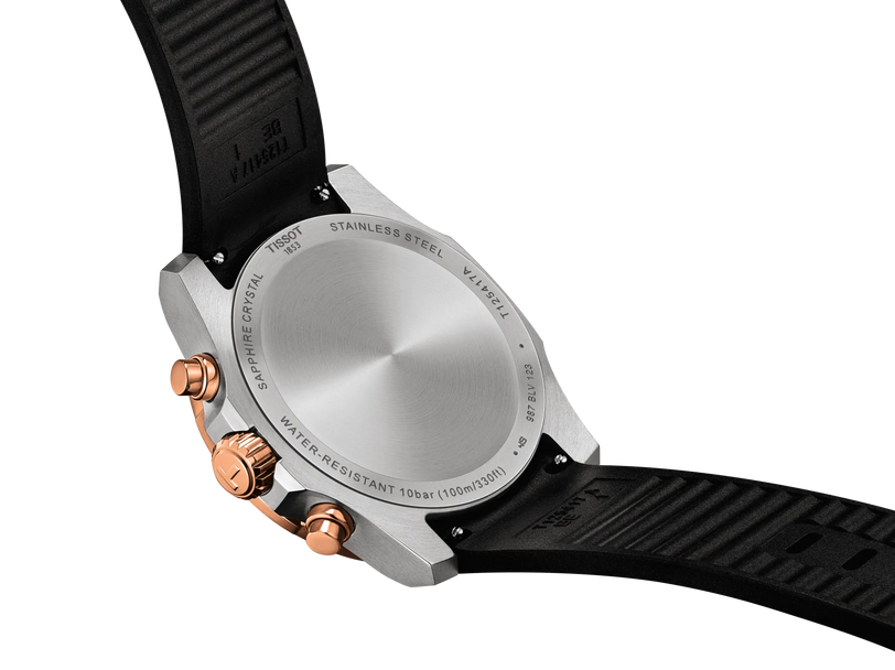 42mm stainless steel chronograph watch with rose gold pushers, silver dial, and black rubber strap.