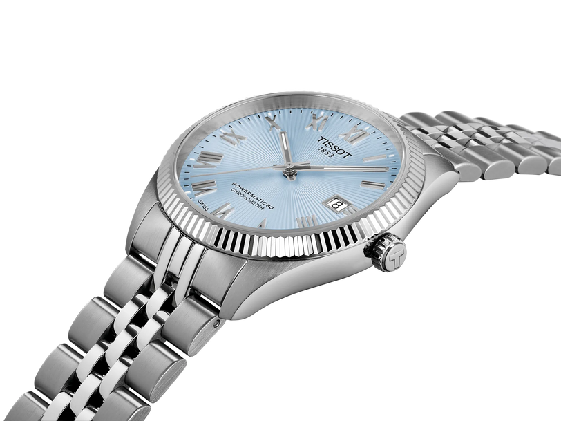 Stainless steel watch with ice blue dial, textured bezel, date window, and matching bracelet band.