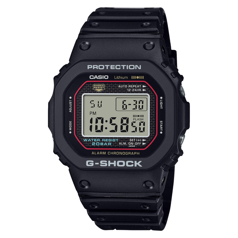 Black G-Shock digital watch with LCD display, red accents, and resin band against white background.