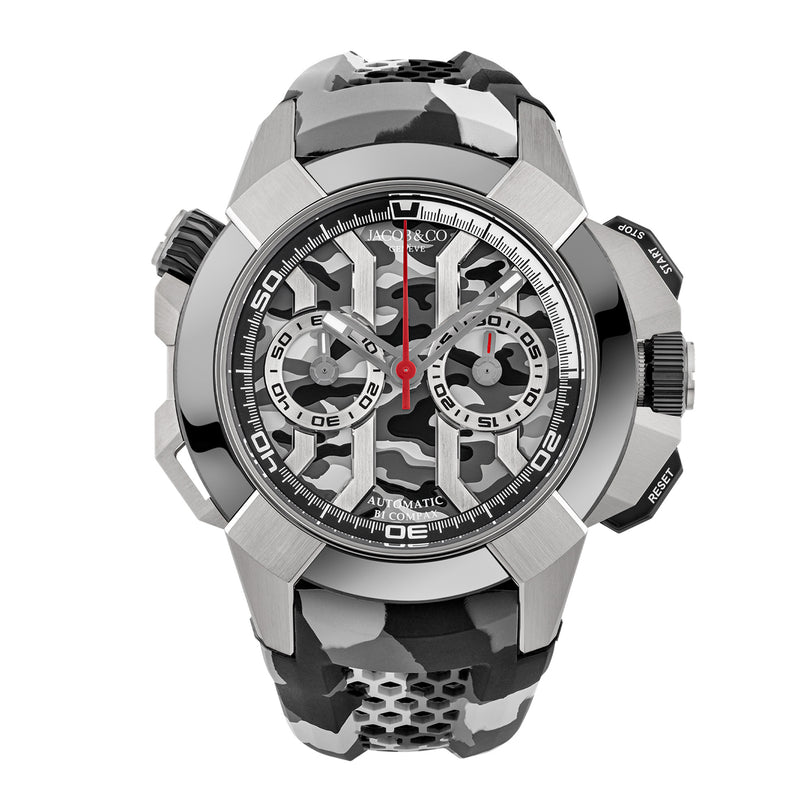 Steel chronograph watch with skeletal dial, visible automatic movement, two subdials, red hands, and black rubber strap.