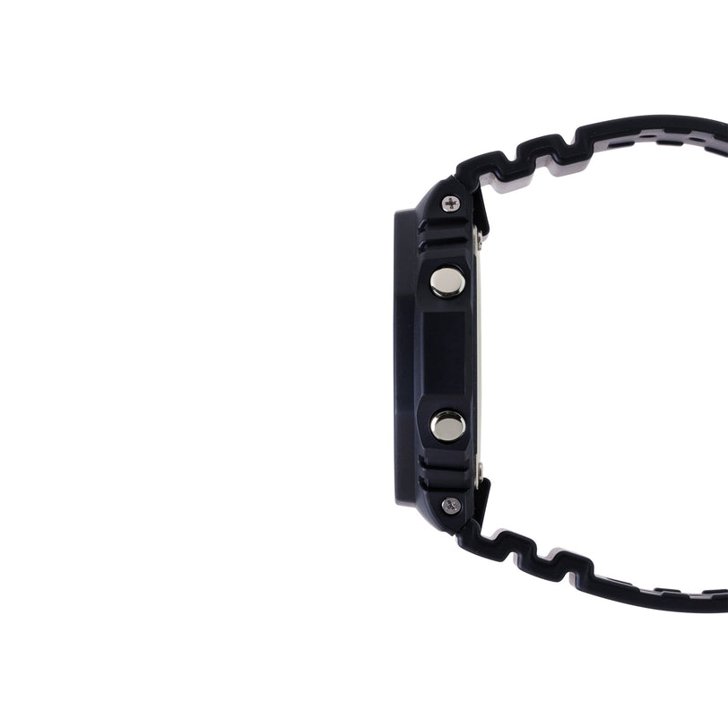 Black resin digital watch with square face, metal buttons, and textured band shown from the side.