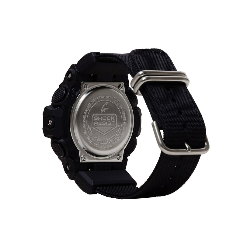 Black digital watch with silver metal case back, black resin band, and silver buckle closure.