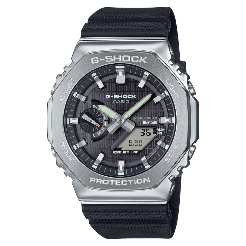 G-Shock stainless steel watch with silver case, black dial, black resin strap, and analog-digital display.
