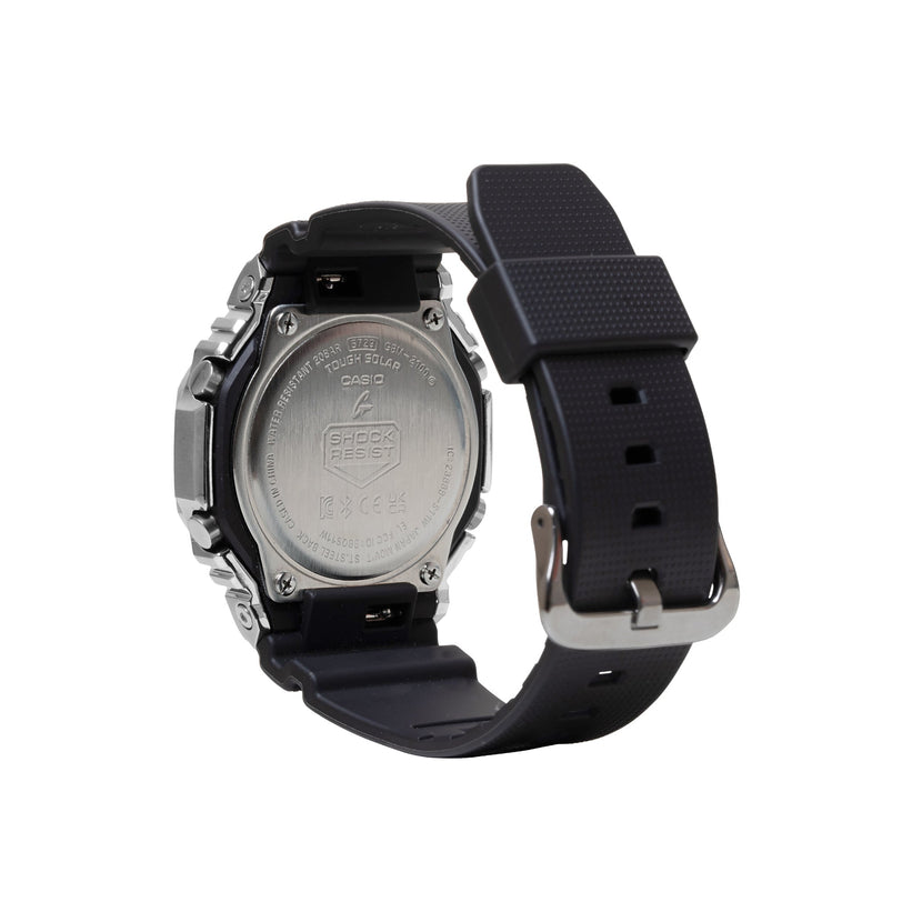 Digital watch with stainless steel and black resin case, black rubber strap, and silver-tone back plate.