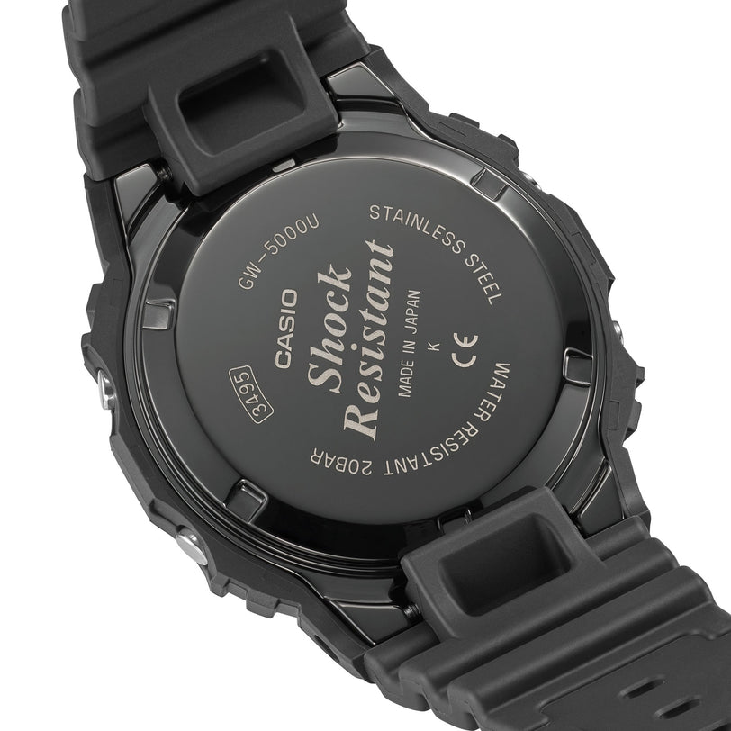 Black resin digital watch with stainless steel caseback displaying model GW-5000U specifications and solar icon.
