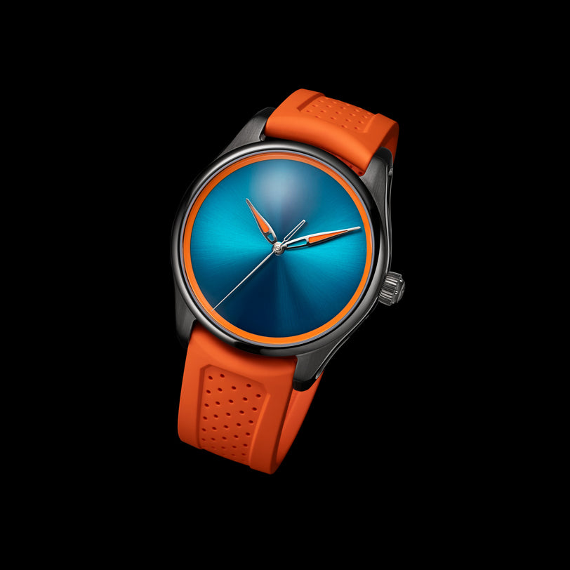 The H. Moser & Cie Pioneer Centre Seconds Spiced Aqua features a blue dial and orange strap, set against a black background.
