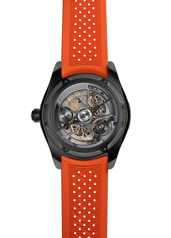 The H. Moser & Cie Pioneer Centre Seconds Spiced Aqua features a black case, an exposed mechanical back, and a bright orange perforated rubber strap.