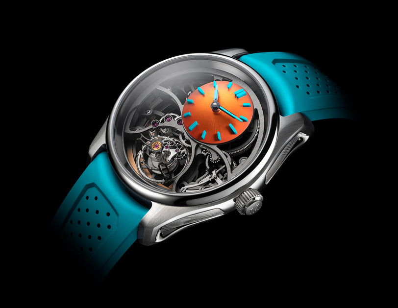 The H. Moser & Cie Pioneer Cylindrical Tourbillon Skeleton Spiced Aqua features an orange and blue dial, visible gears, and a blue perforated strap, displayed against a black background.