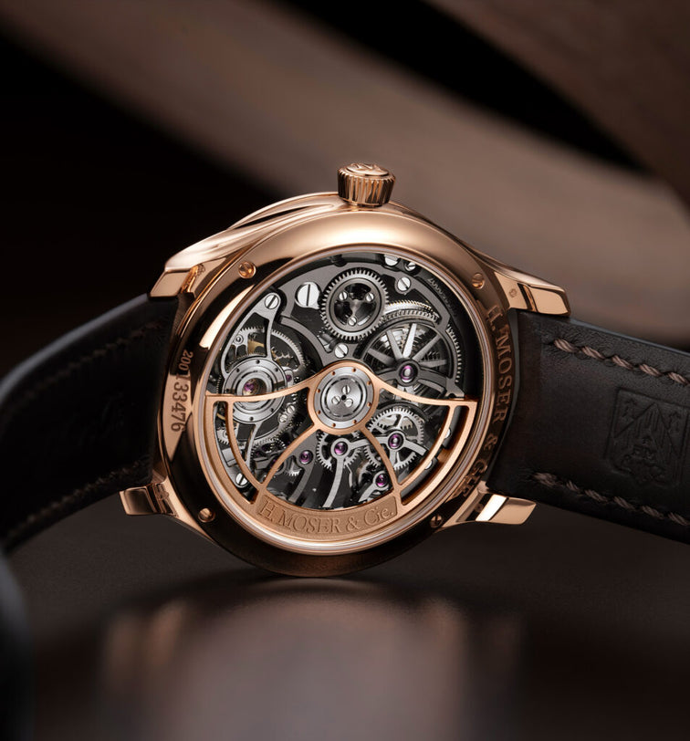 Luxury watch with visible mechanical components on a dark background