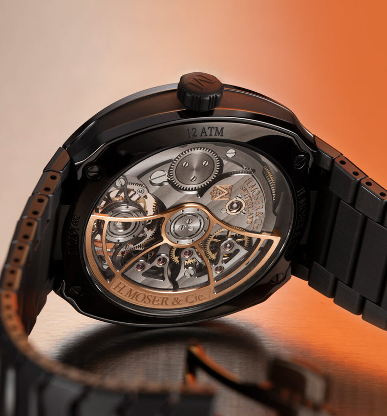 Close-up of a watch with visible mechanical components on an orange gradient background