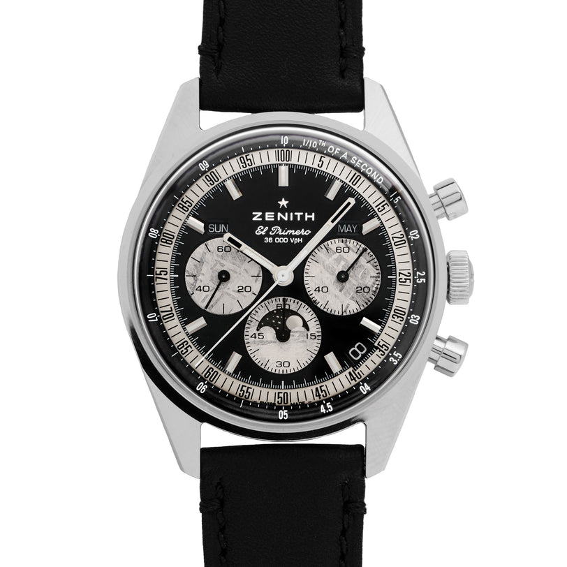 The Zenith Chronomaster Original Triple Calendar Limited Edition for Hodinkee features a black leather strap, black dial with silver sub-dials, and pushers on the right side of its stainless steel case.