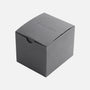 A plain, closed, gray cardboard box with NOT FOR RESALE embossed on the lid, photographed against a white background—possibly linked to the Hublot Classic Fusion Titanium Limited Edition For Hodinkee by Hublot.