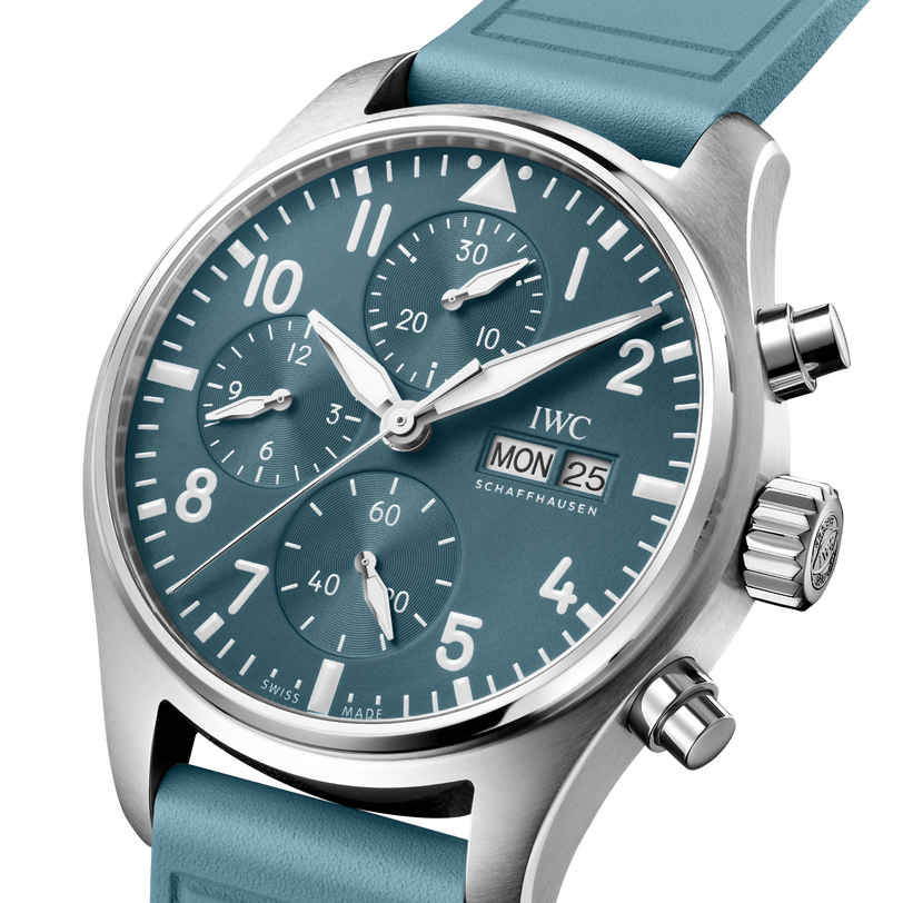 The IWC Schaffhausen Pilot Chronograph Miramar Edition features a teal dial, white numerals, three subdials, and a day-date display.