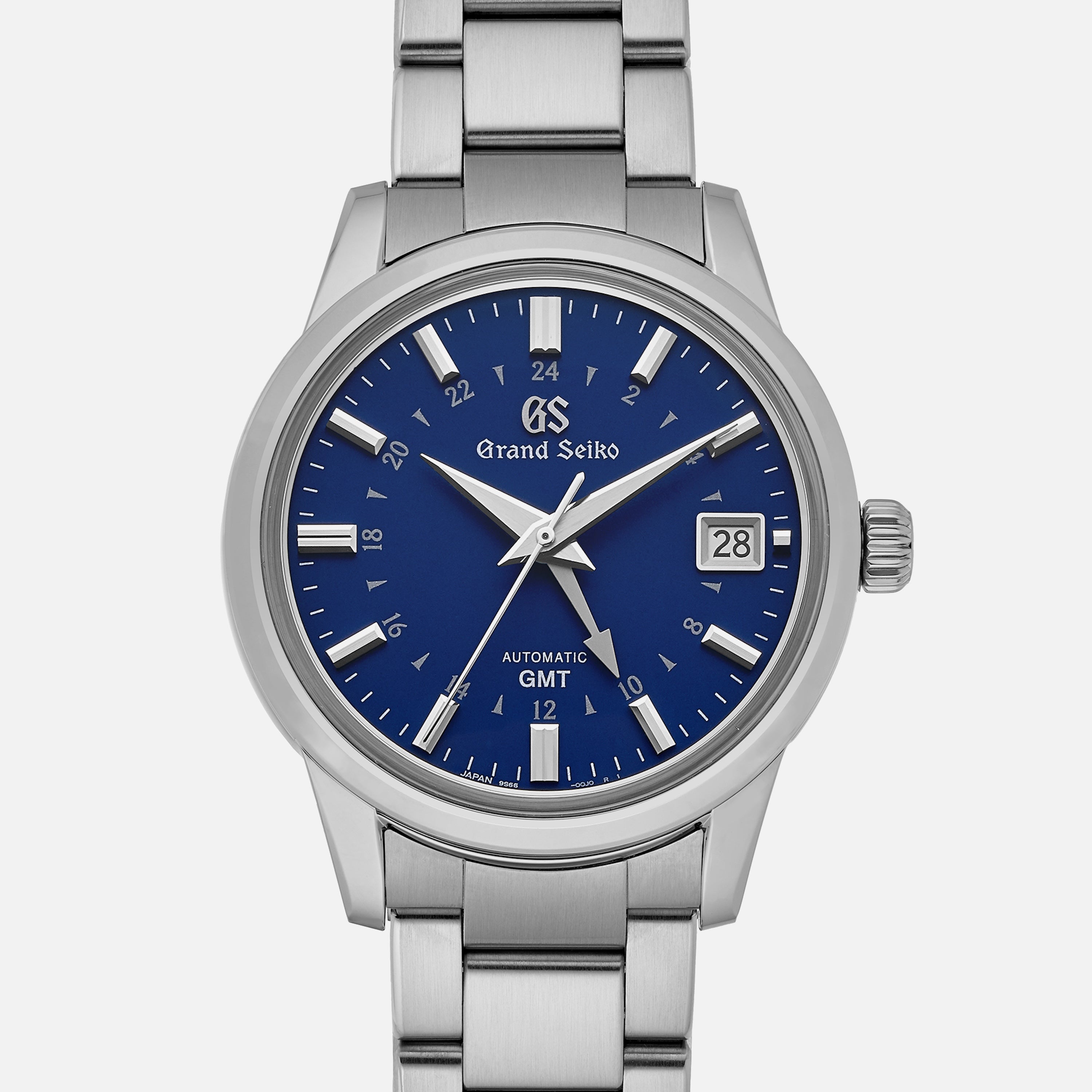 The Grand Seiko Automatic GMT SBGM239 Limited Edition for HODINKEE features a stainless steel case, Twilight Blue dial with silver hour markers, date window at 3 o’clock, and a distinctive GMT hand.