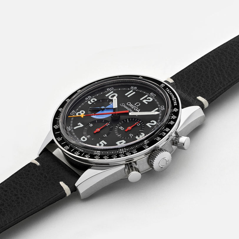 The OMEGA Speedmaster Hodinkee 10th Anniversary Limited Edition chronograph wristwatch features a black leather strap, silver case, and multiple dials with precise movement, shown on a plain white background.