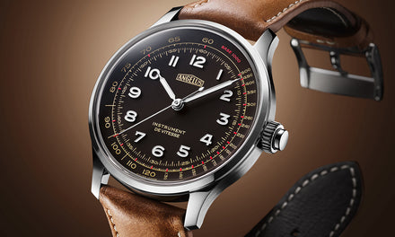 A close up of the face of an Angelus watch with a black dial, brown leather strap, and white numbers over a brown gradient background