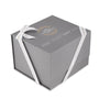A gray gift box with white ribbon, featuring gold and white text reading The Watches of Switzerland Group—ideal for the TAG Heuer Aquaracer Professional 200 or any watch with a stainless steel case and mother-of-pearl dial.