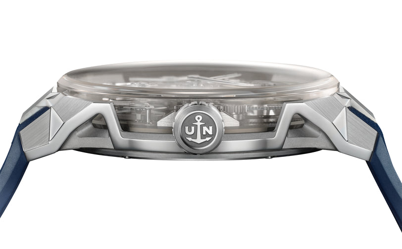 Side view of the Ulysse Nardin Blast Free Wheel Maillechort wristwatch with a silver case, crown featuring an anchor and JN initials, and visible blue strap.