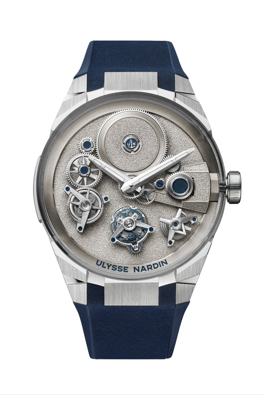 A silver and blue Ulysse Nardin Blast Free Wheel Maillechort watch featuring exposed mechanical gears and a blue strap.