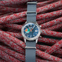 The TAG Heuer Limited Edition Carrera Skipper For HODINKEE, featuring a blue dial and grey strap, rests on coiled red and white rope—a striking choice for collectors and vintage chronograph enthusiasts.