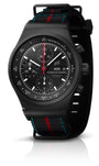 The Porsche Design Chronograph 1 75 Years Porsche Edition features a black case, striped fabric strap, and three sub-dials.
