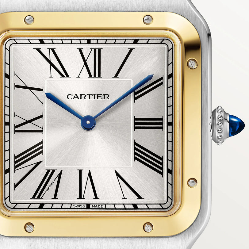 Close-up of a Cartier Santos Dumont watch face featuring Roman numerals, blue hands, and a gold and silver bezel.