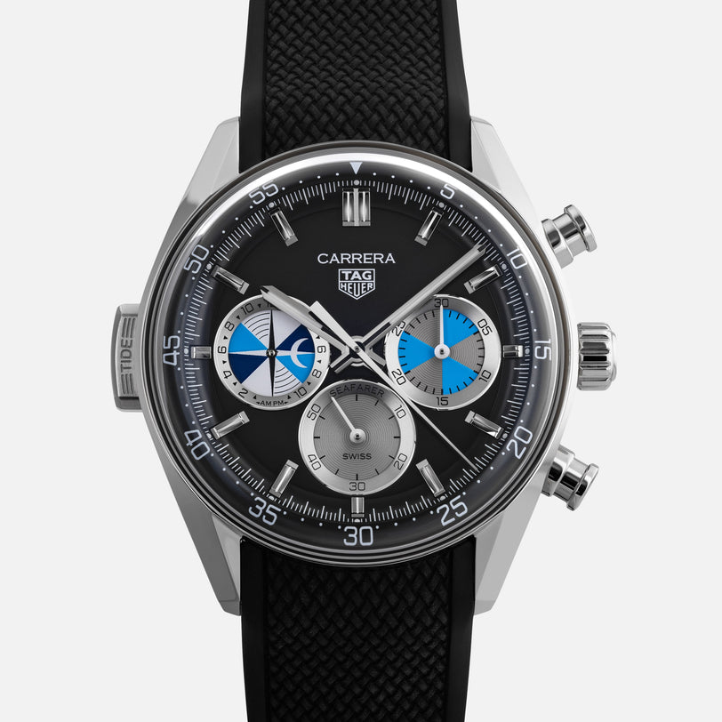 The TAG Heuer Carrera Chronograph Seafarer × Hodinkee features a black strap, silver case, and three subdials with blue and white accents.