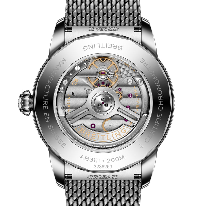 Close-up of the back of a Breitling Superocean Heritage B31 Automatic 42, featuring an exposed mechanical movement and a metal mesh strap.