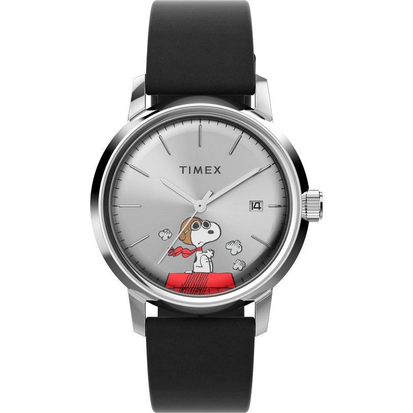The Timex Marlin® Automatic x Peanuts Snoopy Flying Ace watch features Snoopy in aviator goggles on his red doghouse, a black leather strap, silver face, minimalist hour markers, and a date window at 3 o’clock.