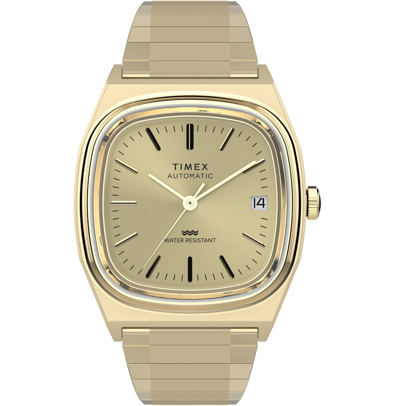The Timex Automatic 1983 E Line Reissue is a gold-tone dress watch featuring a square face, gold dial, black markers and hands, date at 3 o'clock, gold metal link band, Japanese automatic movement, and “WATER RESISTANT” label.