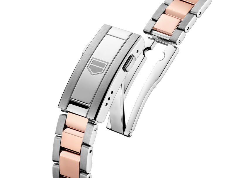 Close-up of a silver and rose gold metal clasp with a geometric logo on the buckle of the TAG Heuer Aquaracer Professional 200 Solargraph watch.