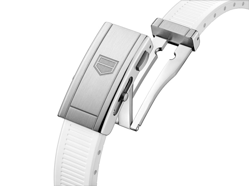 Close-up of the TAG Heuer Aquaracer Professional 300 Date’s silver metal clasp on a white textured rubber strap, shown partially opened.