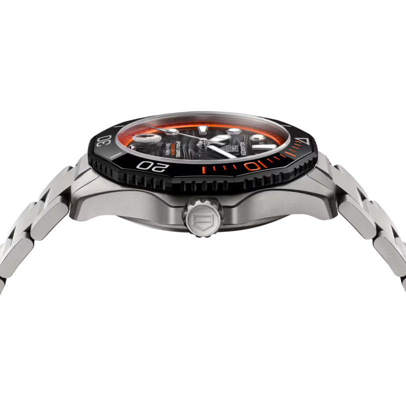 Steel sports watch with orange and black bezel, black dial, and metal bracelet shown from the side.
