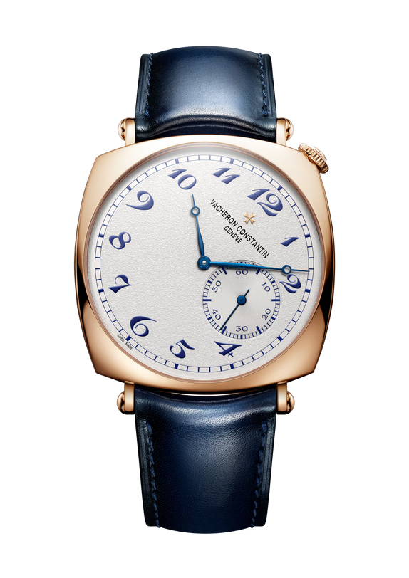 Rose gold square watch with cream dial, blue Arabic numerals, and dark blue leather strap.