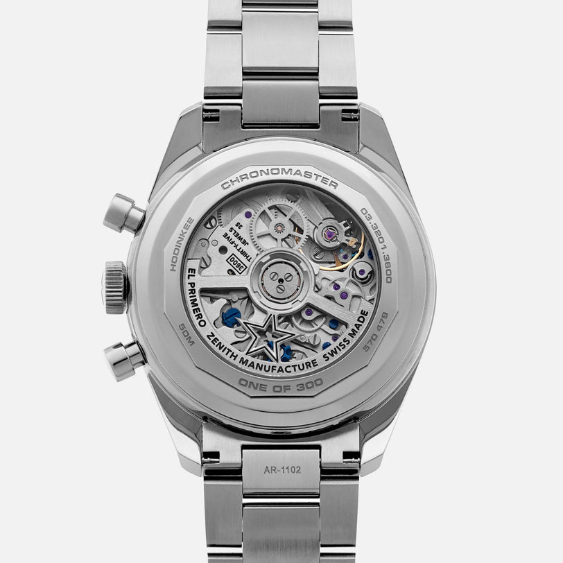 Close-up of the Zenith Chronomaster Original Limited Edition For Hodinkee by Zenith, showcasing its classic design with exposed mechanical movement and engraved details on the metal case and bracelet—a standout El Primero model.