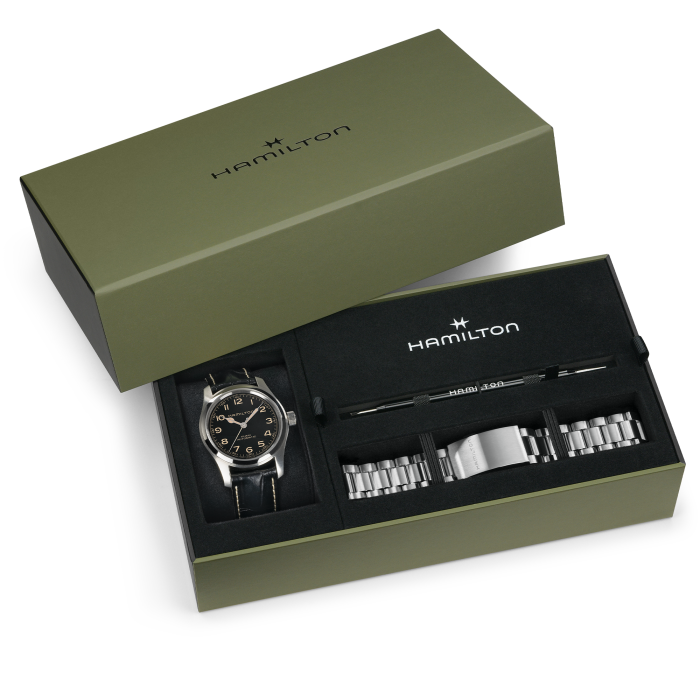 The Hamilton Khaki Field Murph Auto gift set includes a watch, metal bracelet, and tool, all presented in a green box.