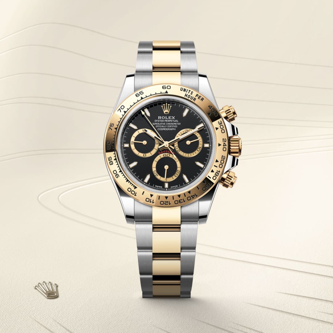 A Rolex Daytona watch with a silver and gold band, black dial, and gold accents displayed on a light background.